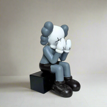 Kaws sitting