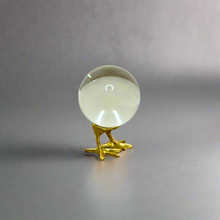 Crystal ball on gold stand