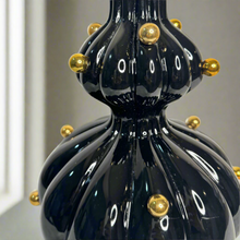 Black glossy vase with gold balls