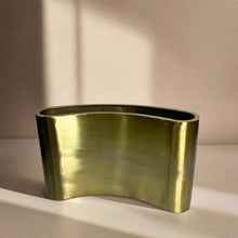 Curved metal vase