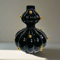 Black glossy vase with gold balls