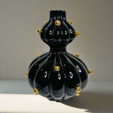 Black glossy vase with gold balls