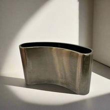 Curved metal vase