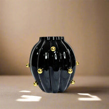 Black glossy vase with gold balls