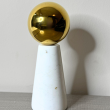 White marble ornament with gold ball