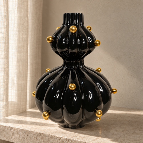 Black glossy vase with gold balls — lifestyle